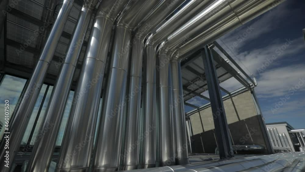 Pipes on a roof of a shopping center in Rome. Technical area in a moderne architecture of a shopping centre. Pipes on a roof of a shopping center in Rome. Technical area in a moderne architecture of a shopping centre.
