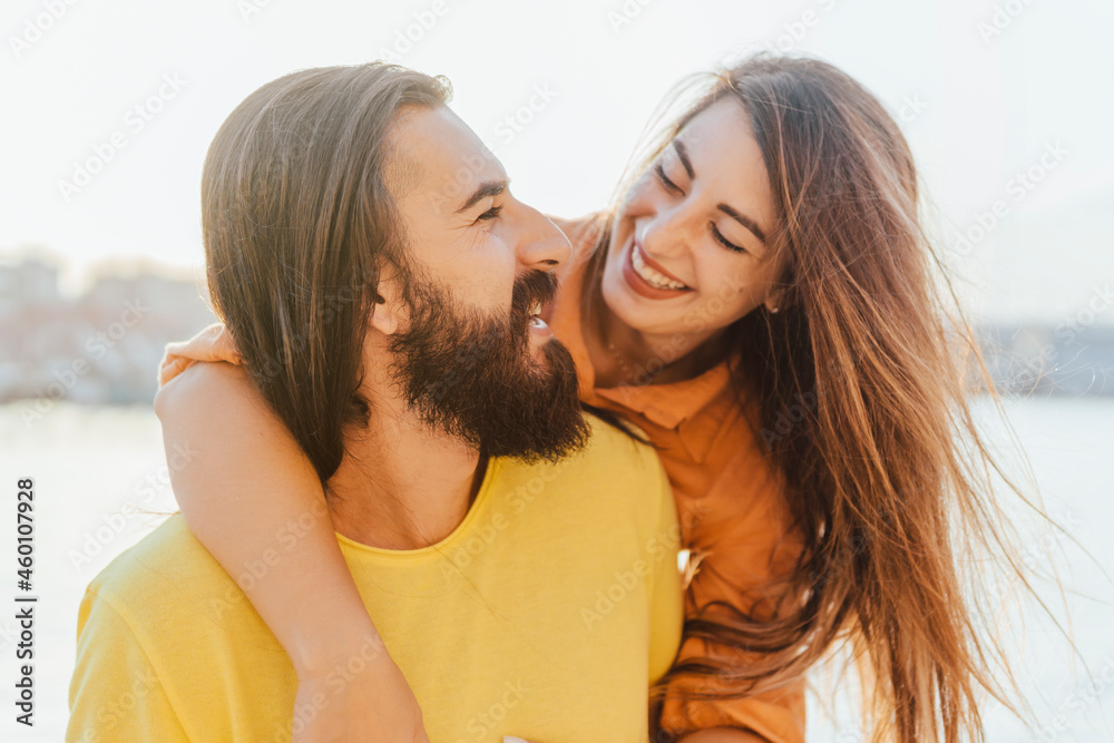 Happy couple on summer vacation hugging each other - love, people and lifestyle concept. Happy couple on summer vacation hugging each other - love, people and lifestyle concept.