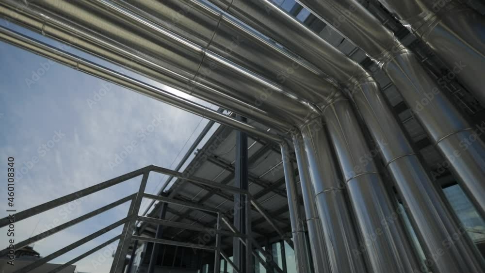Pipes on a roof of a shopping center in Rome. Technical area in a moderne architecture of a shopping centre.