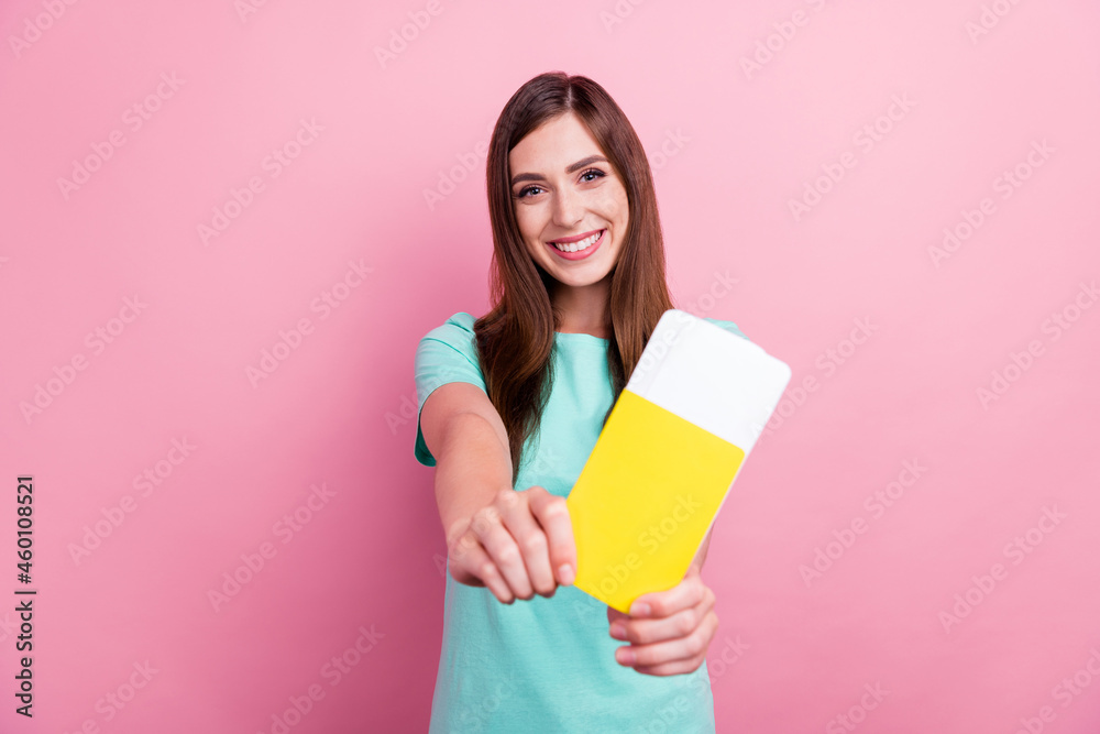 Photo of charming sweet young woman dressed turquoise t-shirt showing you passport smiling isolated pink color background Photo of charming sweet young woman dressed turquoise t-shirt showing you passport smiling isolated pink color background