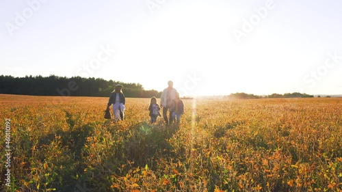 Wallpaper Mural Happy group of young caucasian parents and two amazing children siblings walking across wheat field and enjoying fun adventures in countryside. Torontodigital.ca