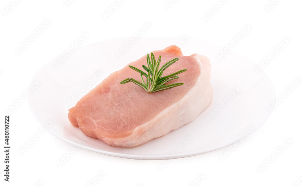 Raw pork in white plate on dark background Raw pork in white plate on dark background