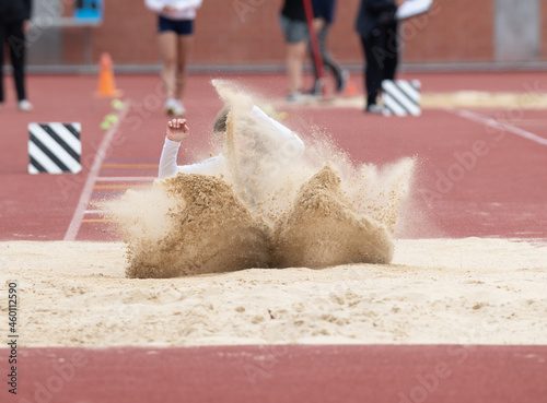 Long jumpers competing at a track and field meet photo