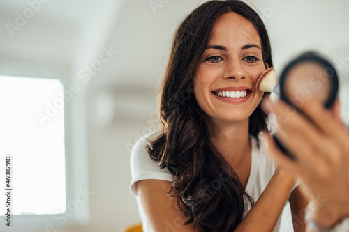 Photos Adult woman, trying out the new blush she ordered online.
