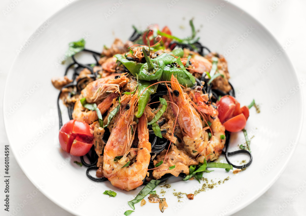 black squid ink spaghetti pasta with shrimp and mixed vegetables