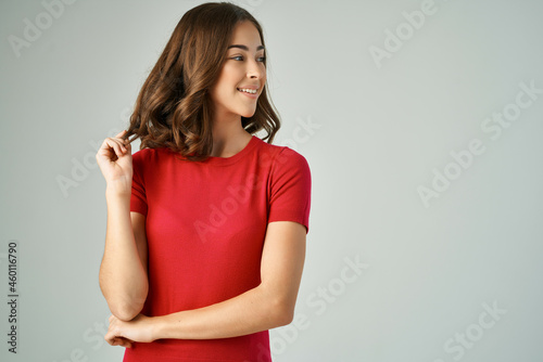 cheerful woman in a white t-shirt hair care isolated background