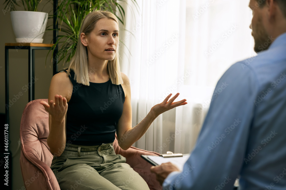 psychotherapy - male psychotherapist or psychiatrist conducting counselling with young woman. mental health disorder - obrazy, fototapety, plakaty 