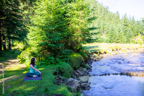 woman do yoga at river beach