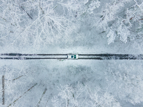 view of the white car from above in frozen winter forest