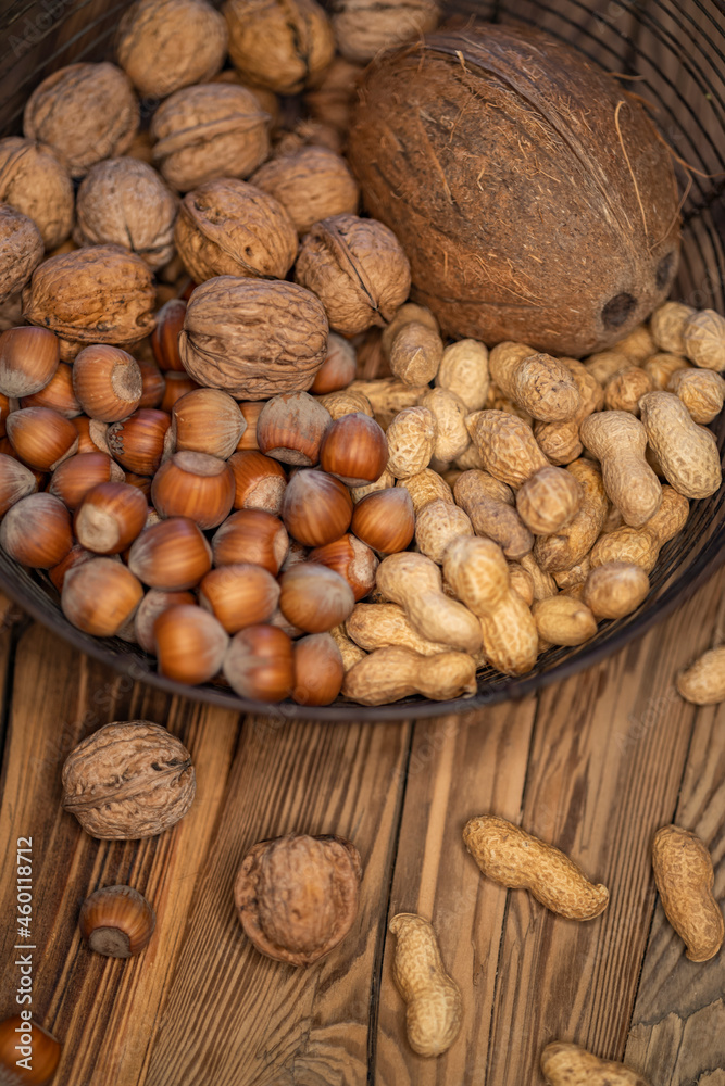 different kinds of nuts on a wooden background different kinds of nuts on a wooden background