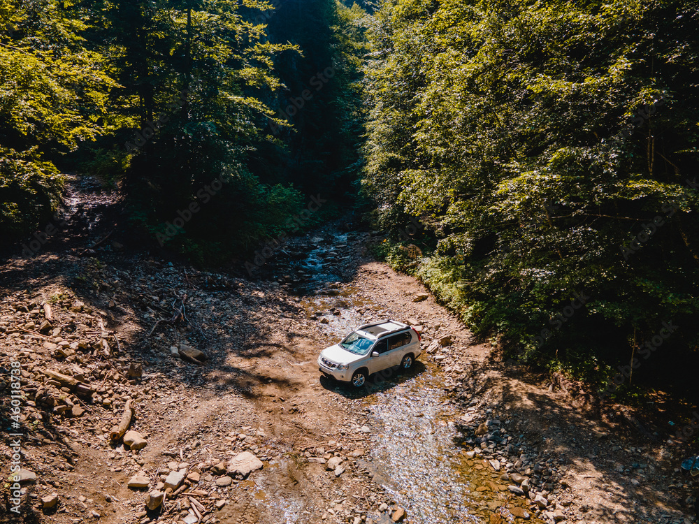 suv car mountains creek on background