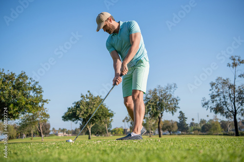 golfer in cap with golf club. people lifestyle. unshaven man playing game on green grass.