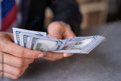 businessman counts money in hands. savings, finances, economy and home concept - close up of man counting money at home