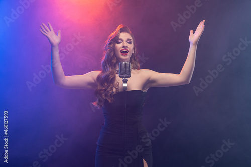 Canvas Print Cropped image of beautiful talented stage singer isolated over gradient blue pur