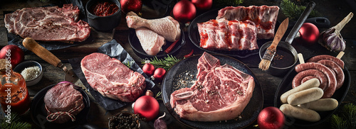 Assorted fresh meat on table with Christmas baubles