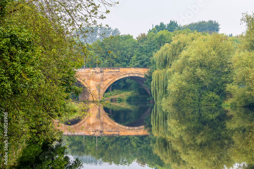 A view along the River Tees towards the Yarm Bridge at Yarm, Yorkshire, UK in summertime