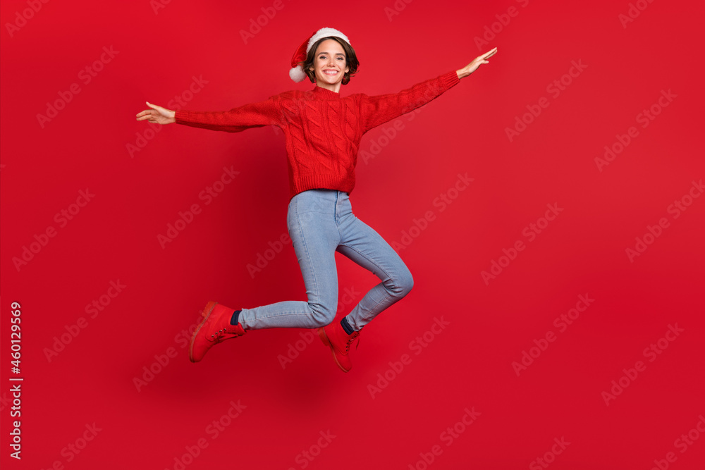 Full body photo of young excited girl happy positive smile jumper holiday noel isolated over red color background