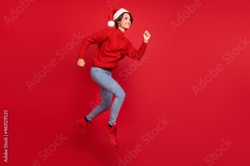 Full body profile side photo of young girl happy positive smile run season shopping sale isolated over red color background