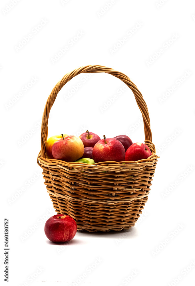 Basket of fresh, ripe apples on white. Various red and green apple fruits in wicker basket. Basket of fresh, ripe apples on white. Various red and green apple fruits in wicker basket.