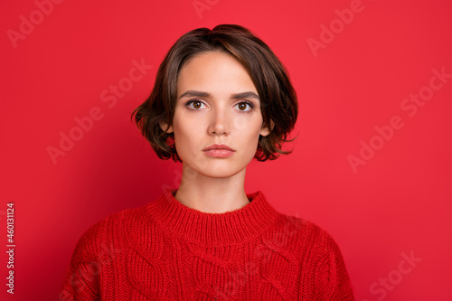 Photo of young attractive woman serious confident wear sweater new year isolated over red color background © deagreez