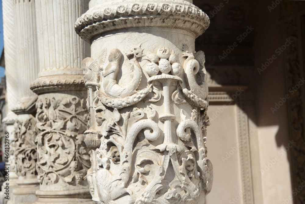 Baroque bas-reliefs and ornaments on the columns of a church in northern Italy