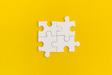 White details of puzzle on yellow background.