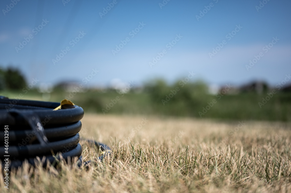 Coil of 1 inch irrigation tubing ready for new installation on top of