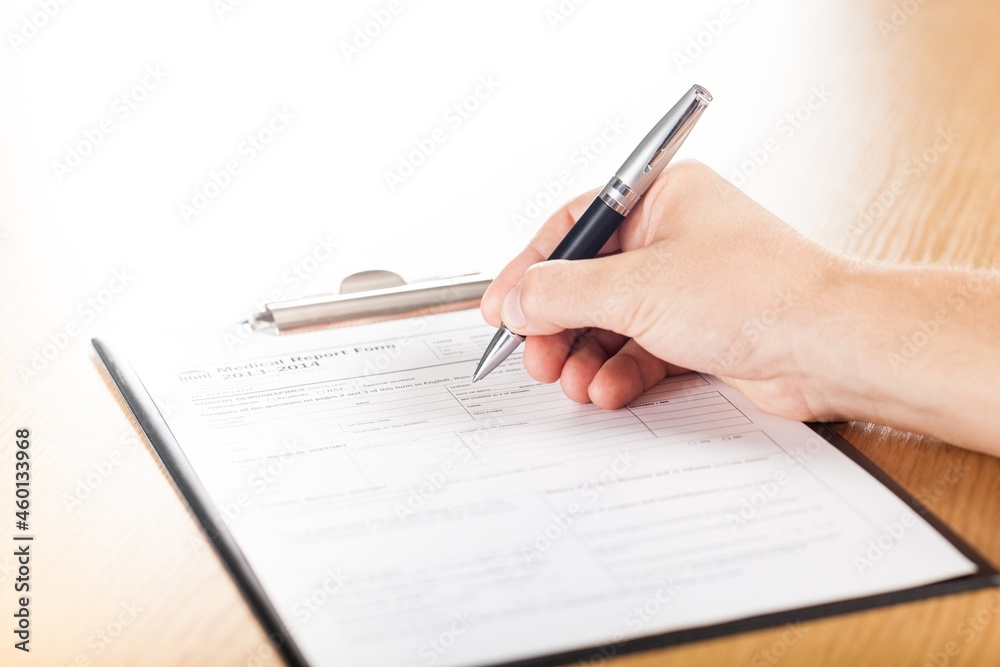 Person Filling a Medical Report Form