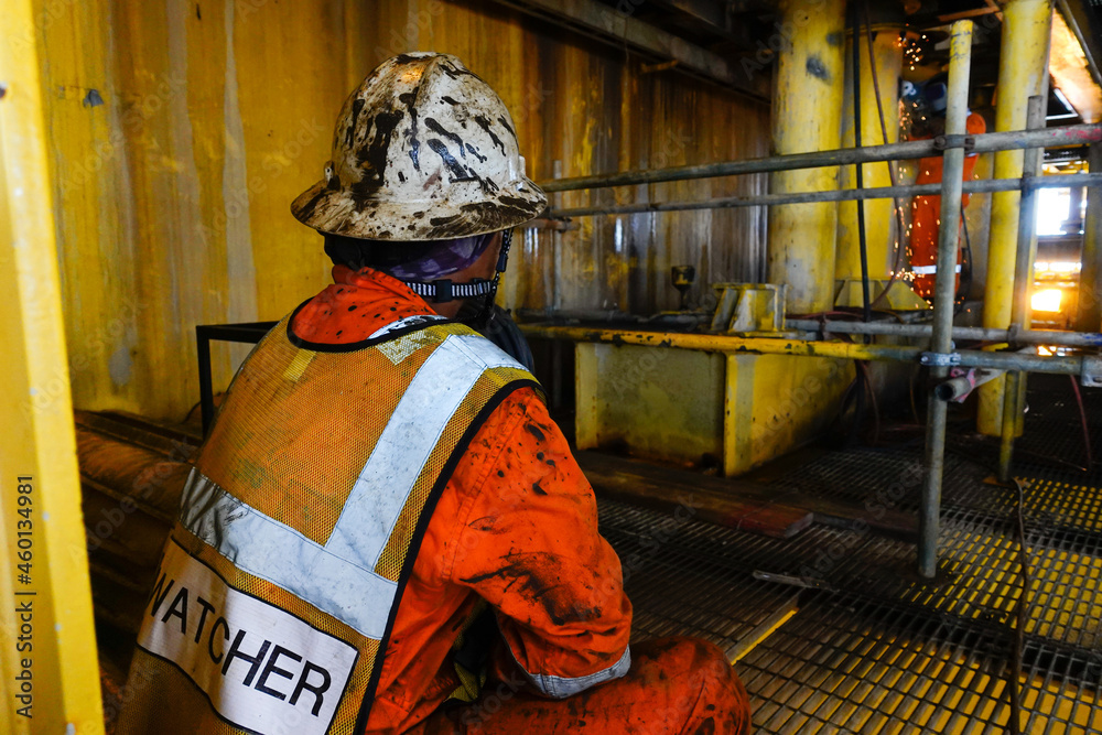 Fire watcher watch welder weld gas pipe casing for stop work in case of