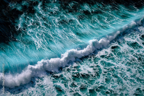 Aerial view to seething waves with foam. Waves of the sea meet each other during high tide and low tide