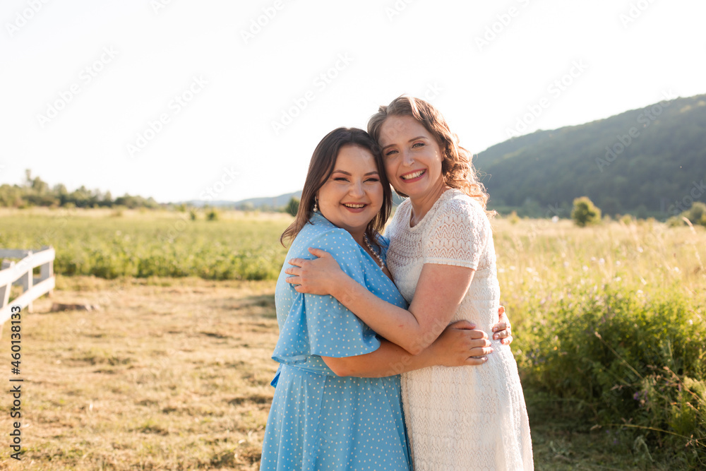 Two sisters hugging each other at the farm Two sisters hugging each other at the farm