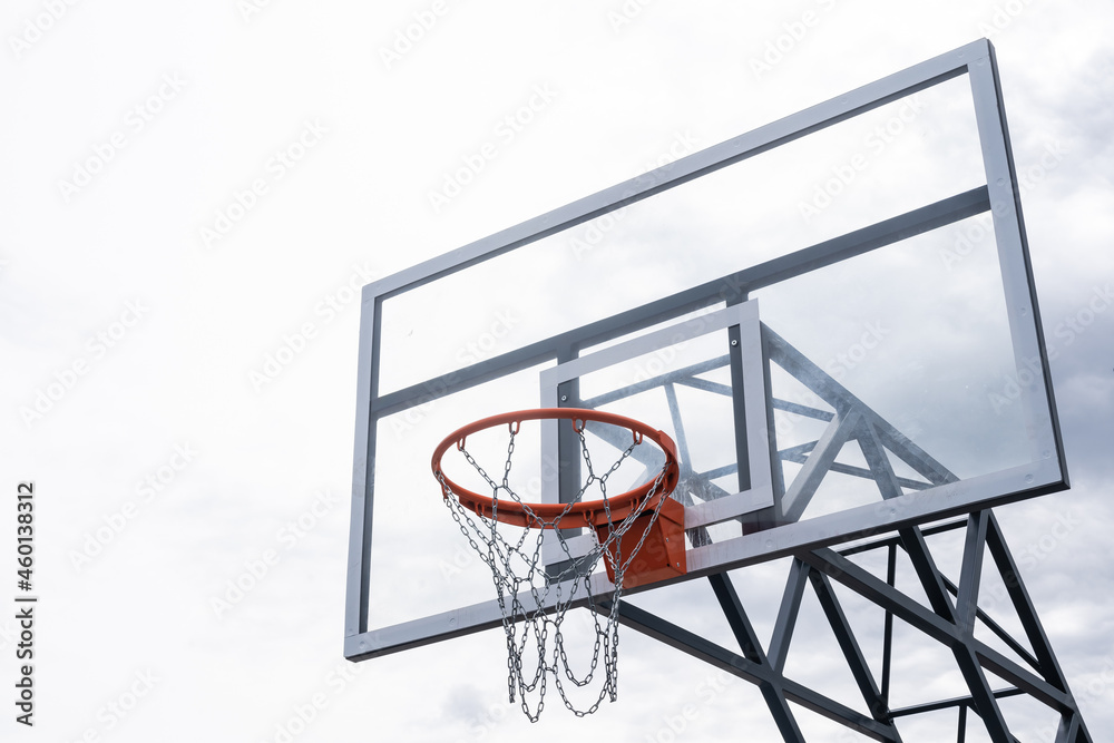 Basketball backboard with a ring, color photo processing. Black and white photo and ring highlighted in red. Focus on the basketball basket as a goal. Basketball backboard with a ring, color photo processing. Black and white photo and ring highlighted in red. Focus on the basketball basket as a goal.