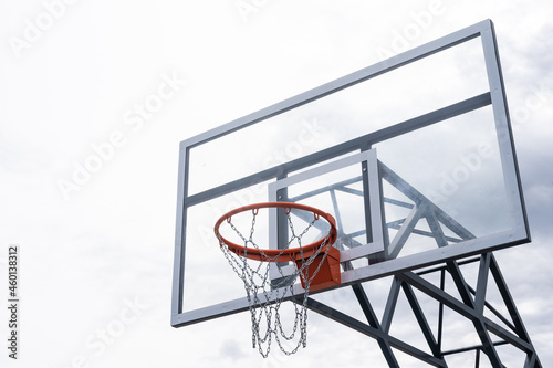 Basketball backboard with a ring, color photo processing. Black and white photo and ring highlighted in red. Focus on the basketball basket as a goal. photo
