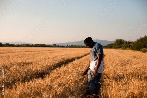 Young farmer standing in the middle of the field