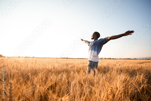 Unspecified man with hands up watching sunset