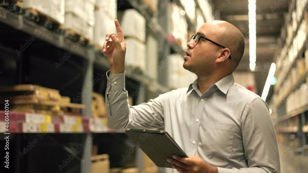 Supply chain. Young manager worker checklist manage parcel box product in warehouse. Asian supervisor man using tablet working at store industry. Logistic import export Distribution warehouse.