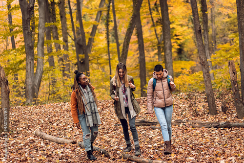 Three female friends enjoying hiking in forest. © Zoran Zeremski