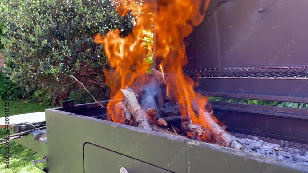 Man using Fire Starter Gel on Barbecue Grill in Yard. Close Up. Slow