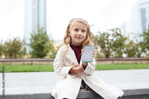Funny child with long hair holding a mobile