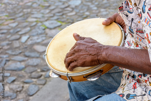 Brazilian samba performance with musician playing tambourine in the streets of Pelourinho, city of Salvador, Bahia photo