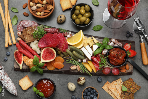 Set of different delicious appetizers served on grey table, flat lay