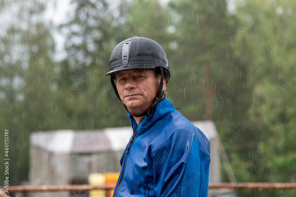 Man horseback riding in forest