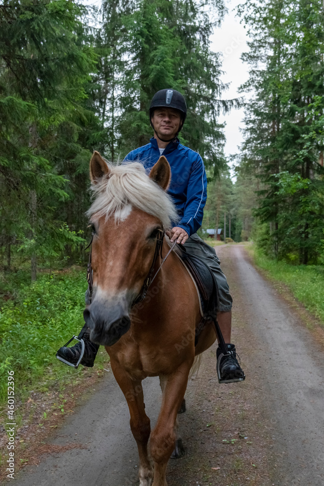 Man horseback riding in forest Man horseback riding in forest