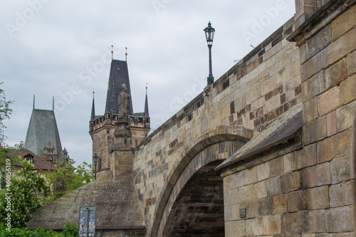 Stone bridge with a tower at the background in the center of Prague, Czech Republic