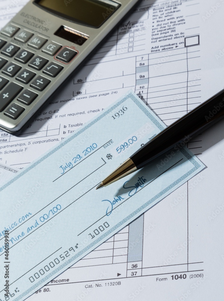 Tax Documents with Calculator,Cheque and Pen Tax Documents with Calculator,Cheque and Pen