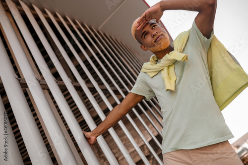 A stylish young man with dyed bearded posing for the camera photo