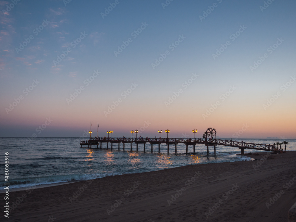 Beautiful sunset overlooking the beach, the sea and the Marbella pier. Colorful sunset