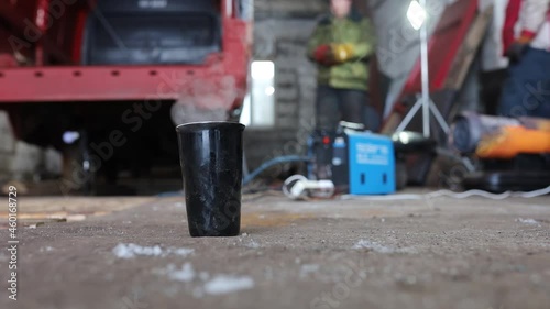 hot drink in a thermos glass in winter at a manufacturing plant photo