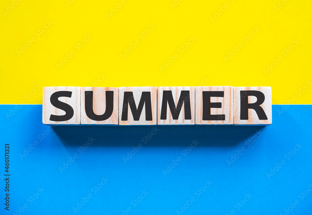Word SUMMER on wooden cubes with word on beautiful yellow and blue background. Business, media marketing concept. Word SUMMER on wooden cubes with word on beautiful yellow and blue background. Business, media marketing concept.