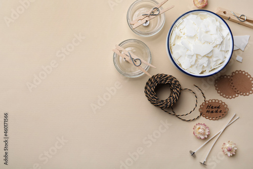 Flat lay composition with homemade candles ingredients on beige background  space for text